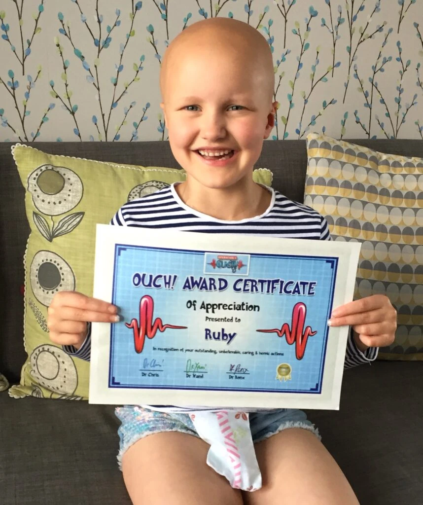 Ruby holding an Operation Ouch Award